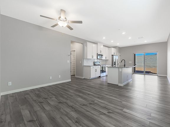 Open-concept layout with the spacious living room leading into the kitchen.