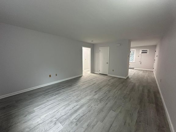 Livingroom looking to kitchen and bedroom hallway
