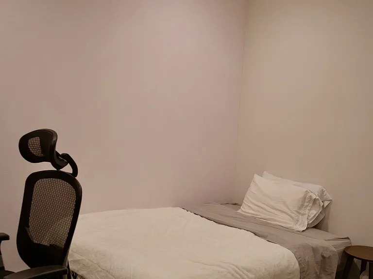 Bedroom 2: Shows the flexible layout of the room, currently accommodating a futon bed setup.