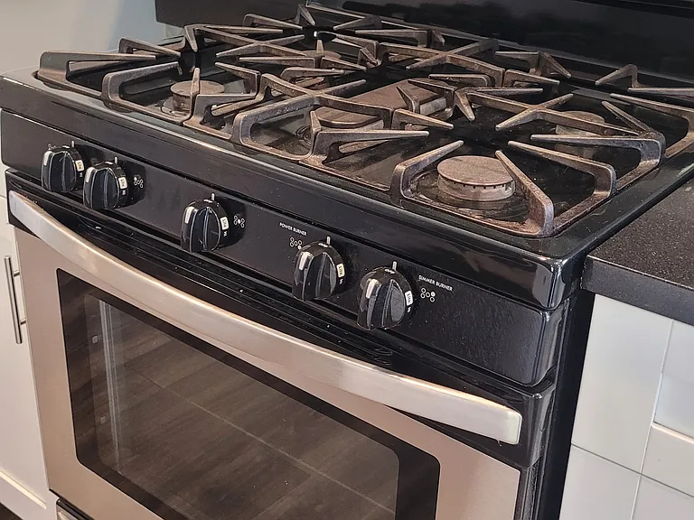 Gas stove and lovely glass tile backsplash
