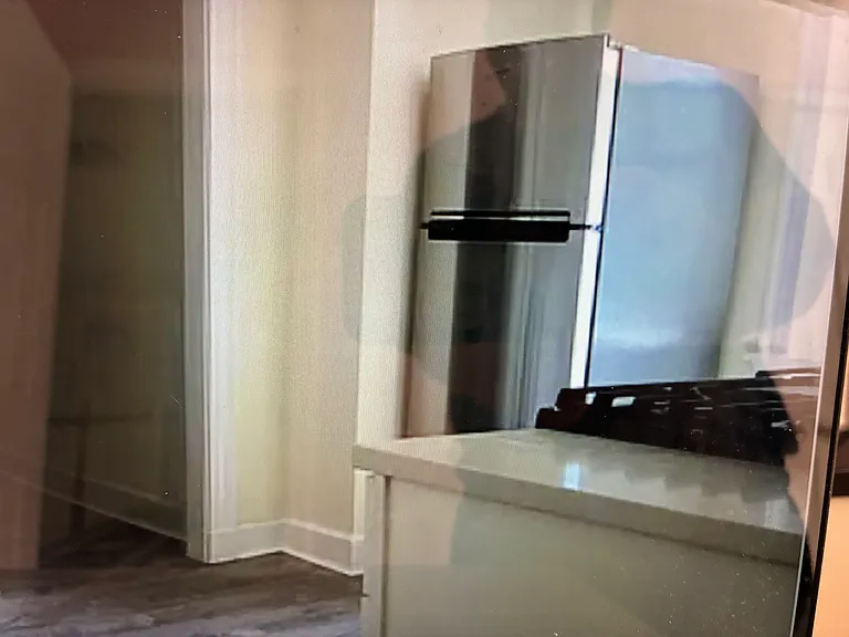 This spacious gourmet kitchen has a large stainless steel refrigerator and freezer.