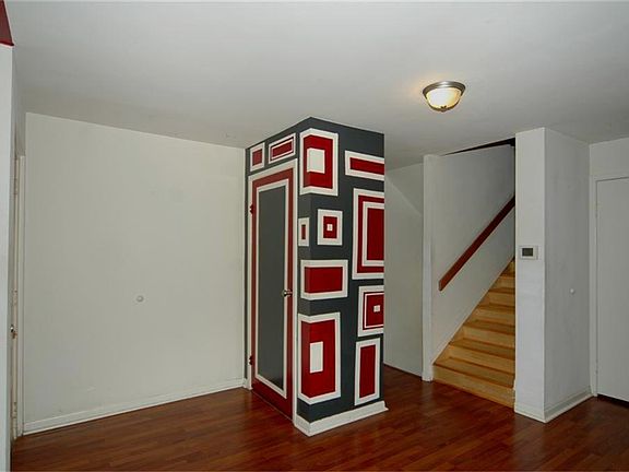 View of the entryway of the townhome. The stairs  have laminate flooring, no carpet means easy maintenance.
