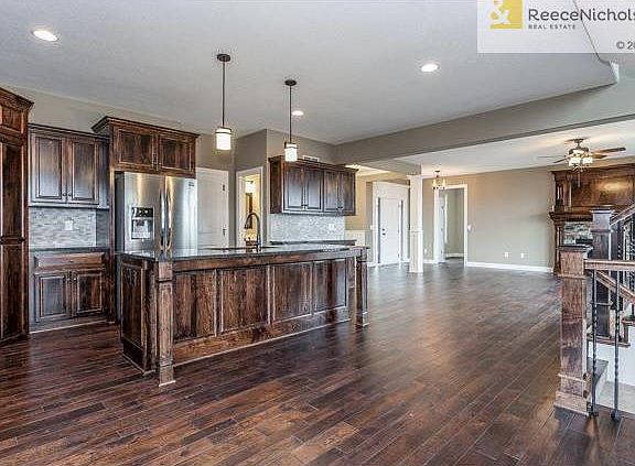 (Upgrade shown: Hardwood Floor in Great Room and Dining Room, Mosaic Backsplash, Buffet, Stainless Steel Finish on Appliances, Fridge)