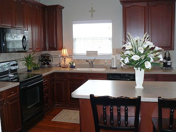 42" cherry cabinets, wood floors, solid-surfact counters