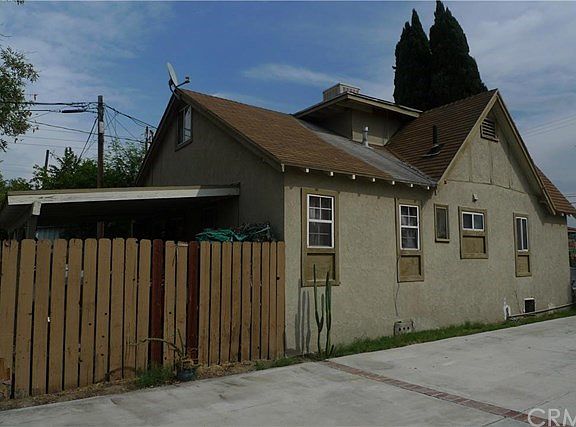 fence of 741, the back yard with carpot behind the fance