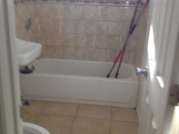 Ceramic bathroom floor and tub surround.