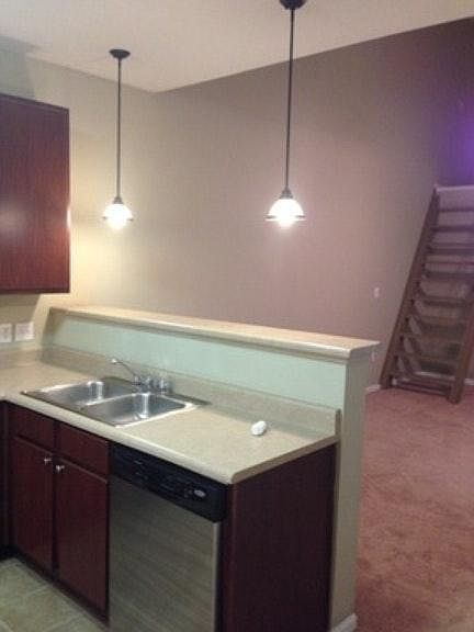 Kitchen view into living room with loft access