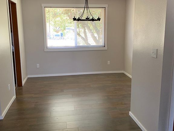 Dining room with new chandelier and flooring and paint.