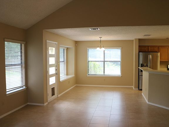 Dining area open to kitchen and living room, and door to back yard.