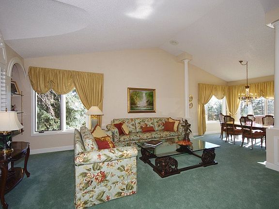 Roman columns in living/dining area enhance the vaulted ceiling.