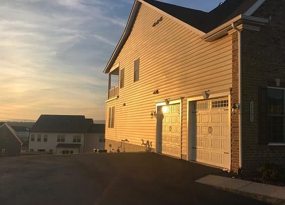 side load garage and master bedroom out side sitting area view at sunset