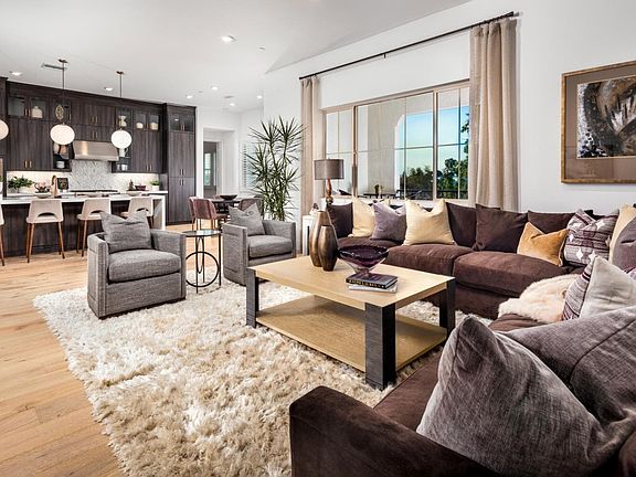 This image showcases the kitchen and great room within the Villas Plan 5 model home.