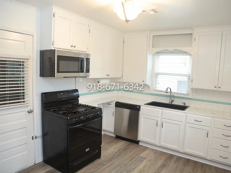 Kitchen showing doorway to large garage with Washer and Dryer hookups.