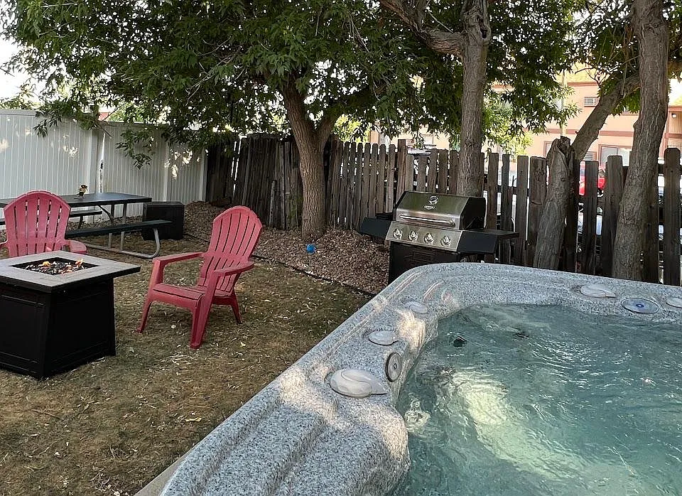 Our property is a true escape with a hot tub, firepit, outdoor seating, and a BBQ grill _ the ultimate recipe for a perfect getaway!