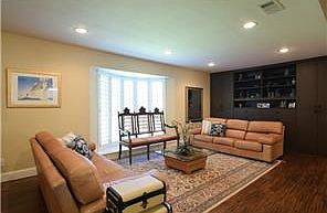 Living Room features Plantation Shutters, Hardwood Floors & Fab Wall of California Closet Built-ins!!