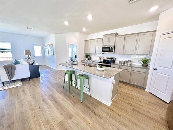 Usable overhang on island allows for at least 4 people to comfortably sit and eat.