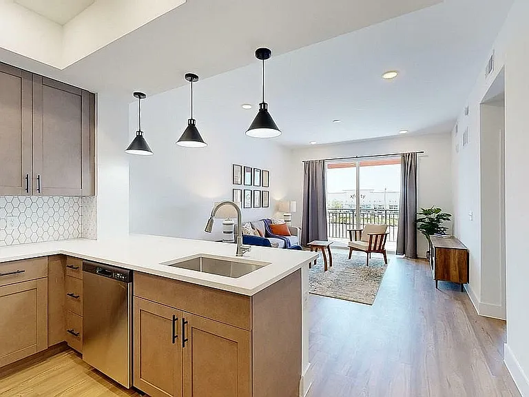 Experience the elegance of this stylish open-plan kitchen and living space, perfect for modern living.