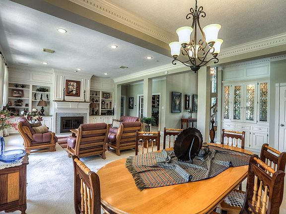 Updated fireplace with glass doors and new surround. Wet bar located behind the leaded glass doors