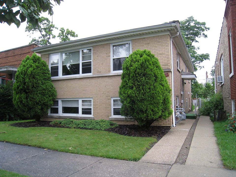 Front view of house from sidewalk. 