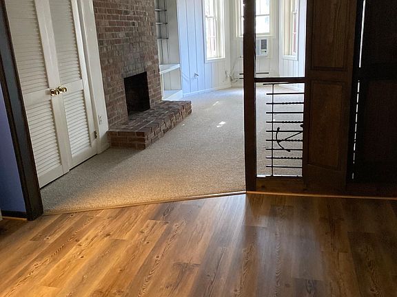 Looking forward from kitchen / work nook towards bay window in front.