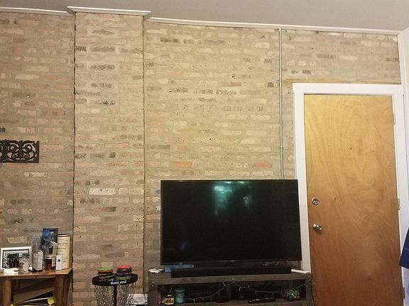Exposed Brick wall in living room and hallway