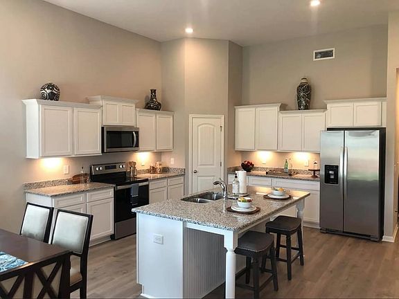Stock Photo Home features a large Kitchen Island, Corner Pantry and all Stainless Steel Kitchen Ap