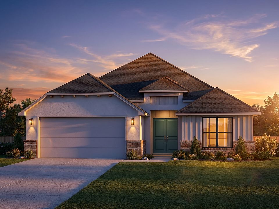 Modern single-story house with a large garage, double front doors, and a well-kept lawn, pictured at