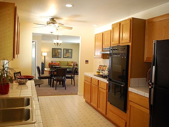 The galley kitchen has a cozy breakfast area, laundry facilities &amp; side door to a large patio