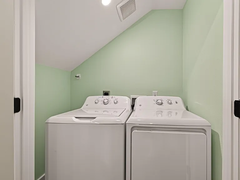 Dedicated laundry closet with a full-size washer and dryer for convenient in-home laundry.