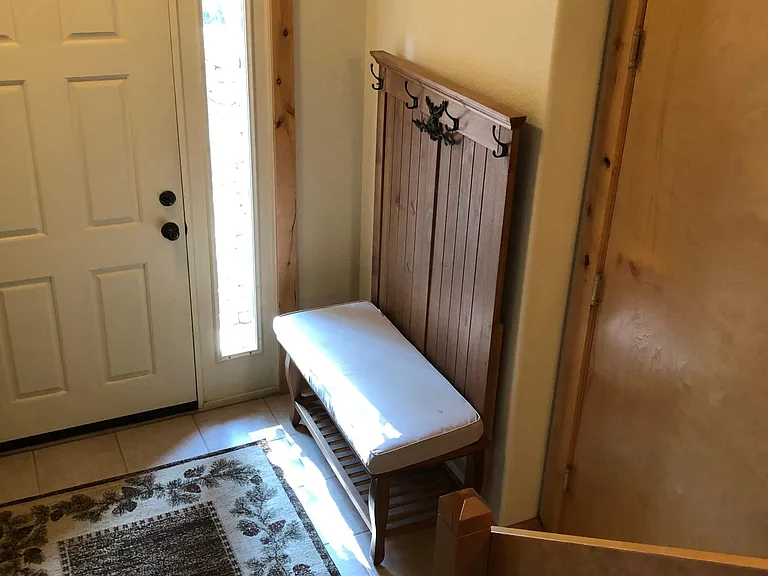 Front Entryway. Hall Tree/bench, and area rug included