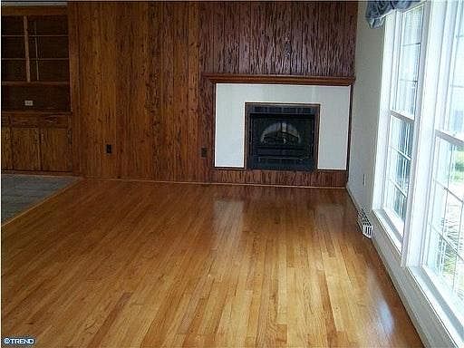 Living room area with hardwood floors and fireplace with uni