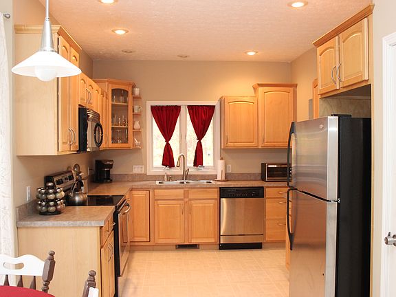 Kitchen faces woods in back