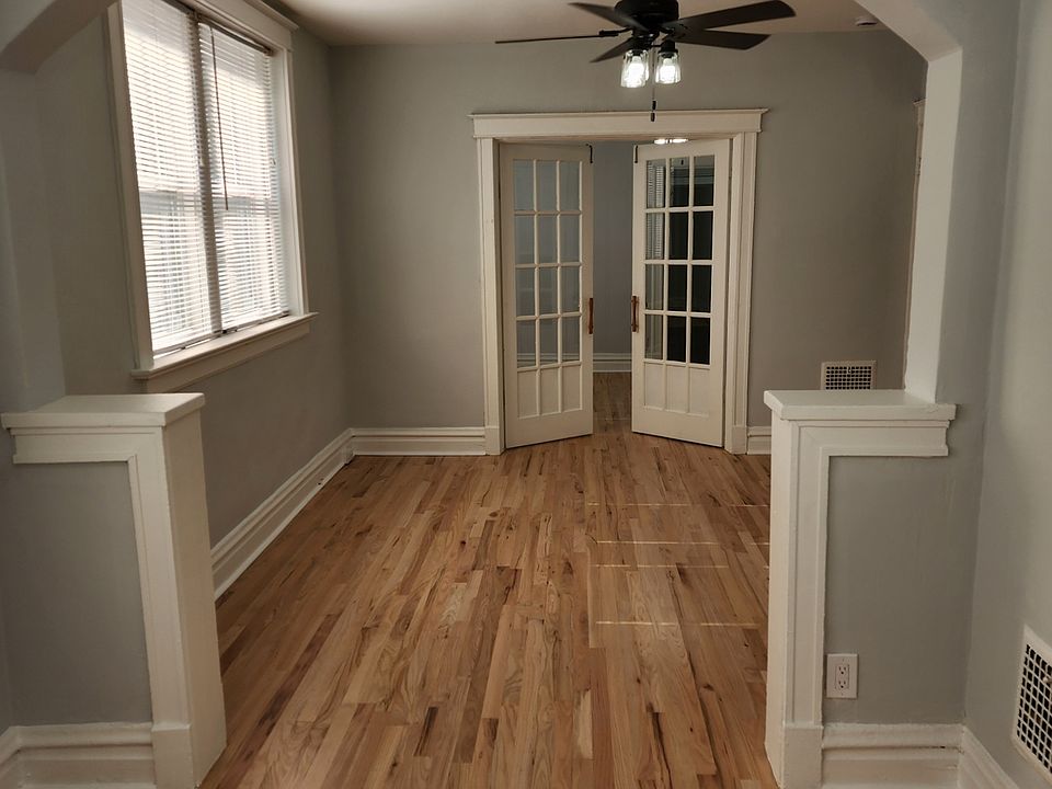 View from the front room look towards the middle two rooms with newly refinished hardwood floors