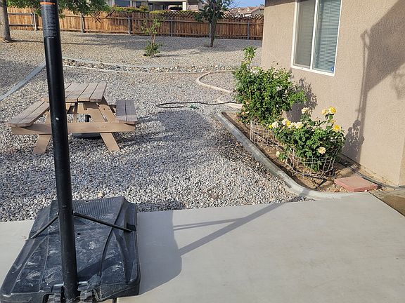 Rear patio with plenty of room for activities. Basketball court not provided and would require approval from owner.