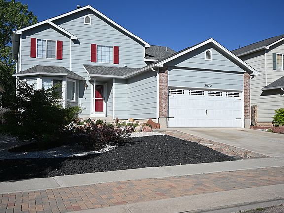 The front of the house with xeriscaping on all sides, no watering needed. Ongoing landscaping included at no cost to the tenant.