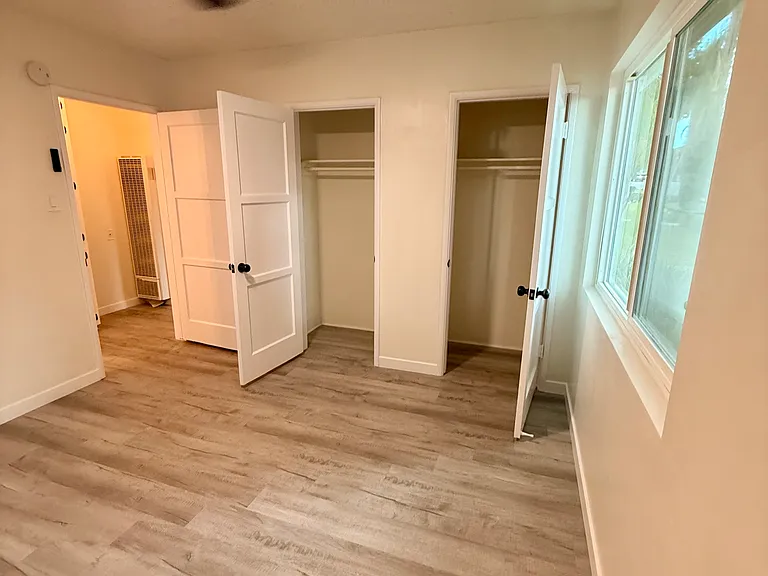 Spacious Bedroom with Dual Walk In Closets, New Dual Pane Windows for Noise and Weather Insulation, New Flooring, New Hardware, New Bluetooth Fan with adjustable lighting, and Blackout Window Treatments...Comfort!