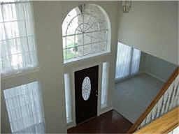 Large two story entry features hardwood floors.