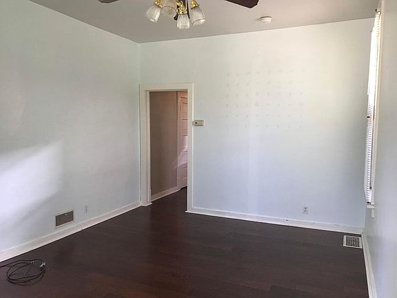 living room with doorway leading back to kitchen, high ceilings