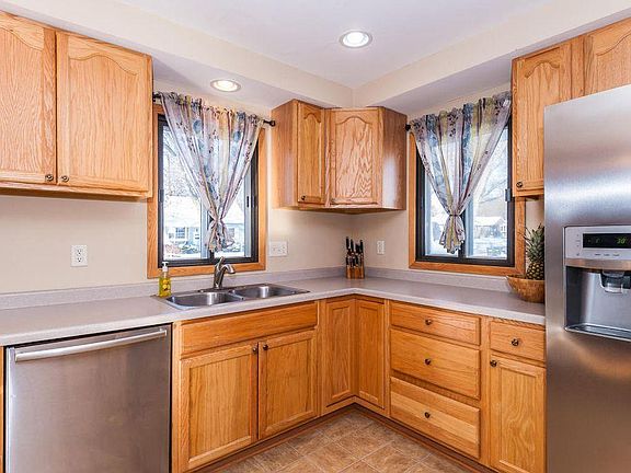 Kitchen with stainless dishwasher and refrigerator.