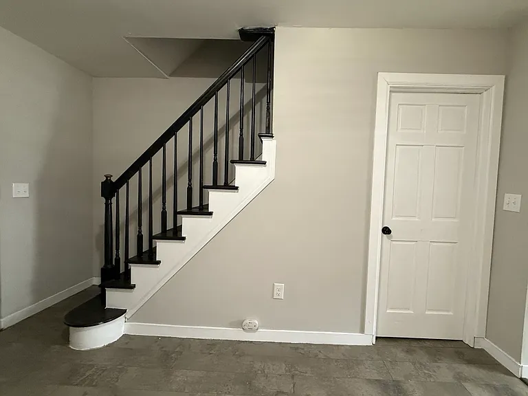 Steps to upstairs and door to the basement