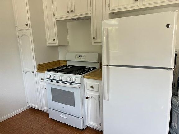 Microwave being installed above the stove.