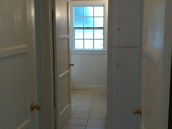 Hallway with storage cabinets.