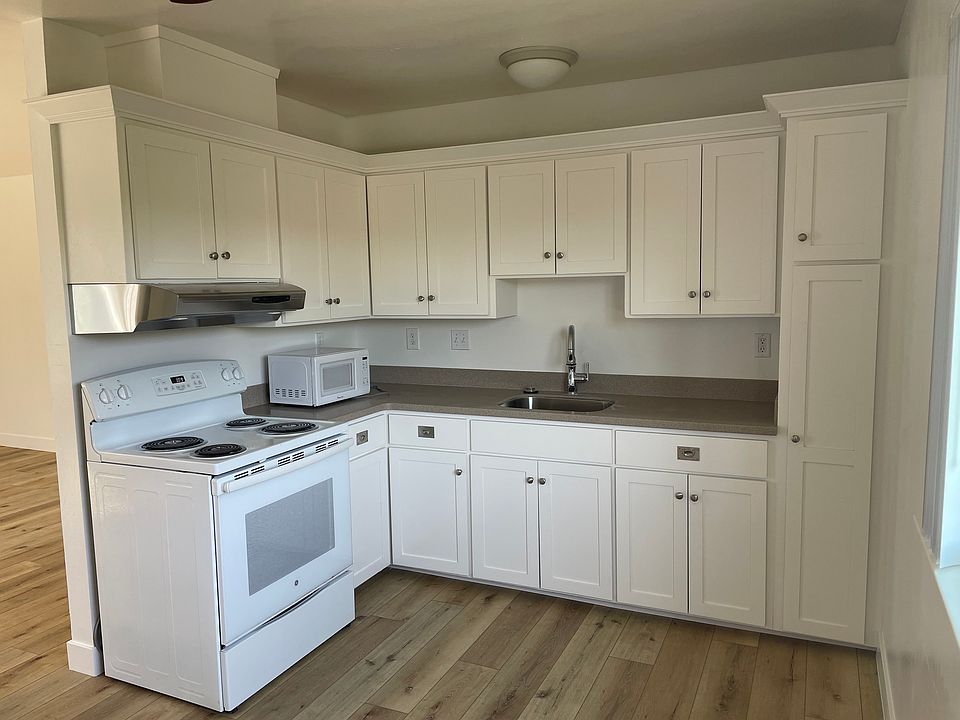 Freshly painted kitchen cabinets and corian countertops.