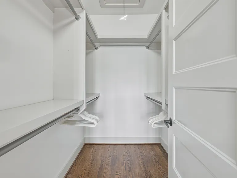 Find a comfortable queen bed in bedroom 3, along with a walk-in closet, dresser, smart TV, and ceiling fan.
