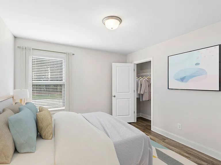 Secondary bedroom with queen size bed and large window letting in a ton of natural light.