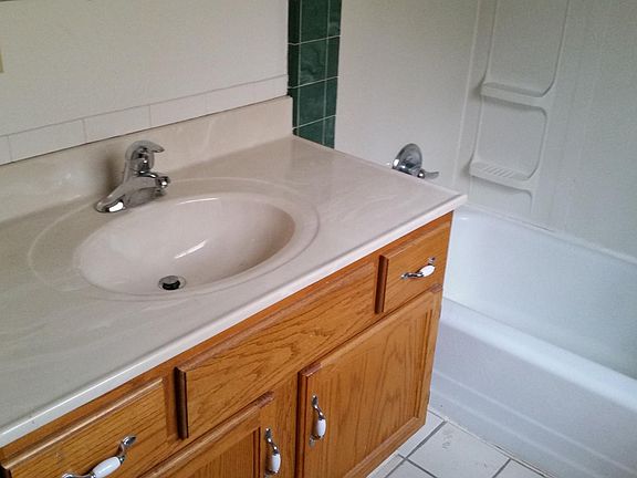 Remodeled upstairs bathroom showing vanity and shower/tub.
