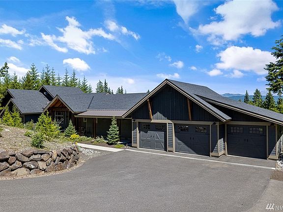 Paved driveway and native landscaping with irrigation provide low maintenance living.