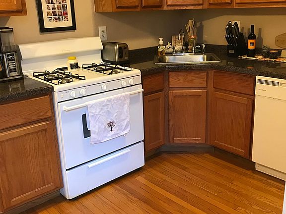 Kitchen with storage cabinets + storage on top. Stove and di