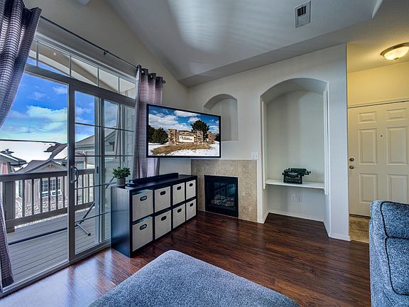 Living area looking west to the balcony and west. Gas fireplace.