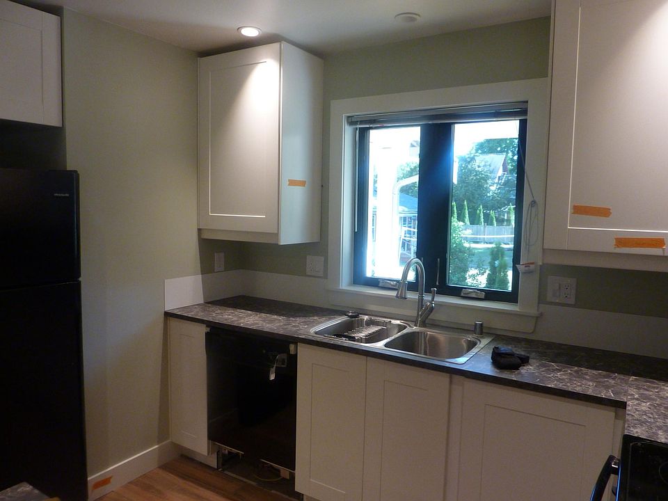 Kitchen with all new appliances: refrigerator, garbage disposal, dishwasher, range. Washer & dryer in closet off hallway.